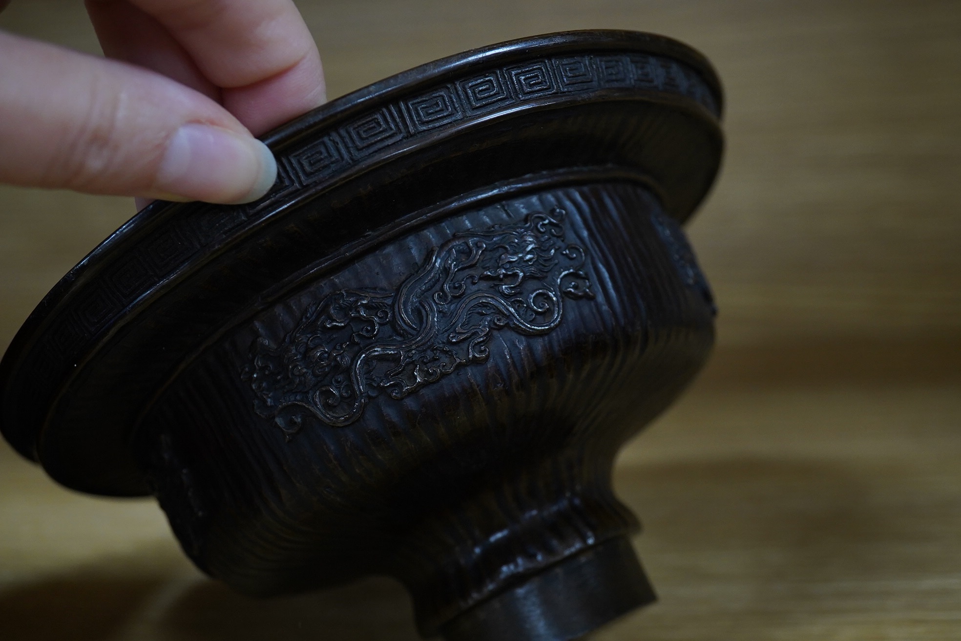 A Chinese bronze bowl, 17cm diameter, a lacquer vase, 15cm high, and a Chinese hand mirror with ivory inlay (3). CITES Submission reference 1UK5HNLM. Condition - fair to good